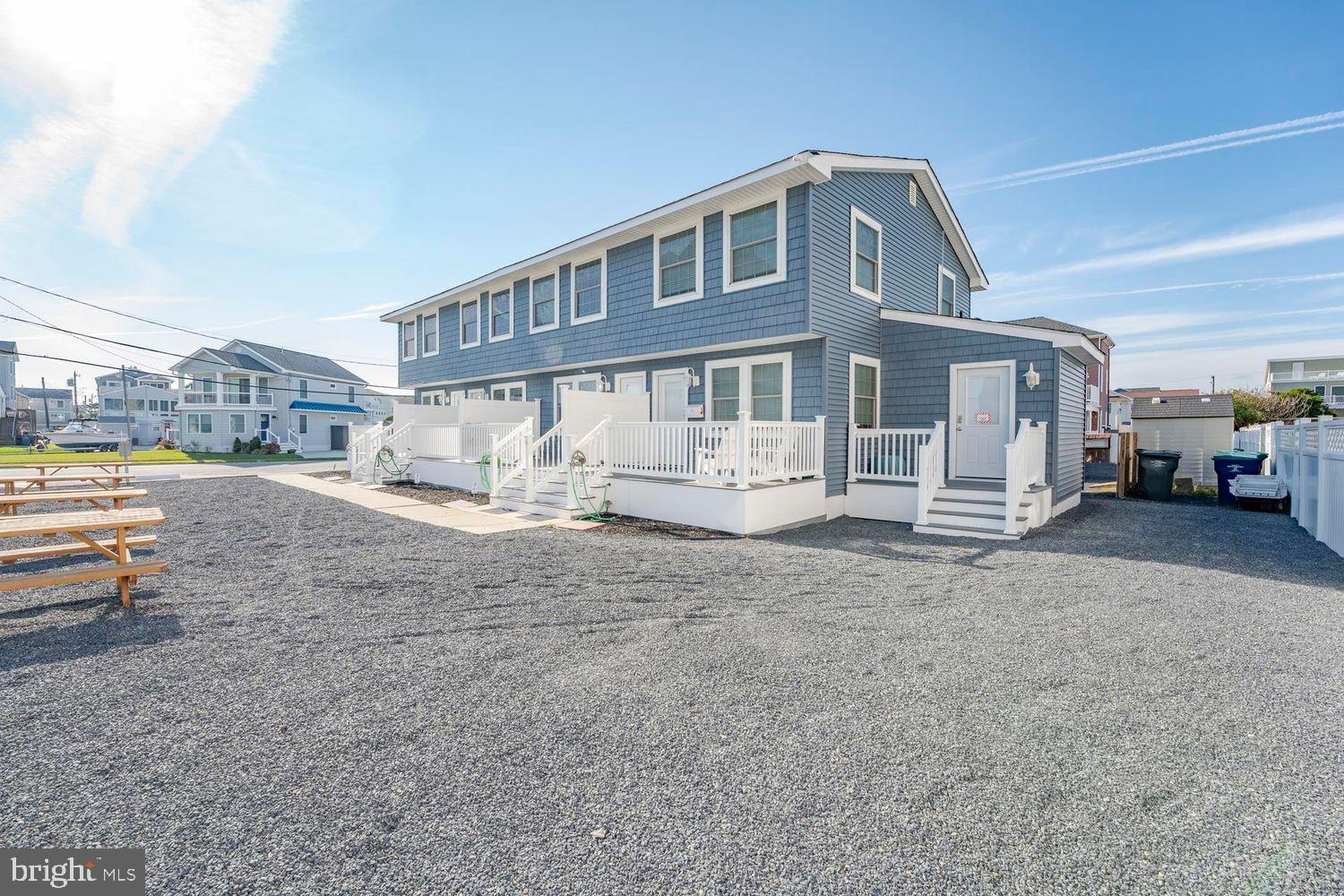 229 10th Street North, Unit 2 Brigantine, NJ 08203 - Photo 19 of 24 a front view of a house with a yard