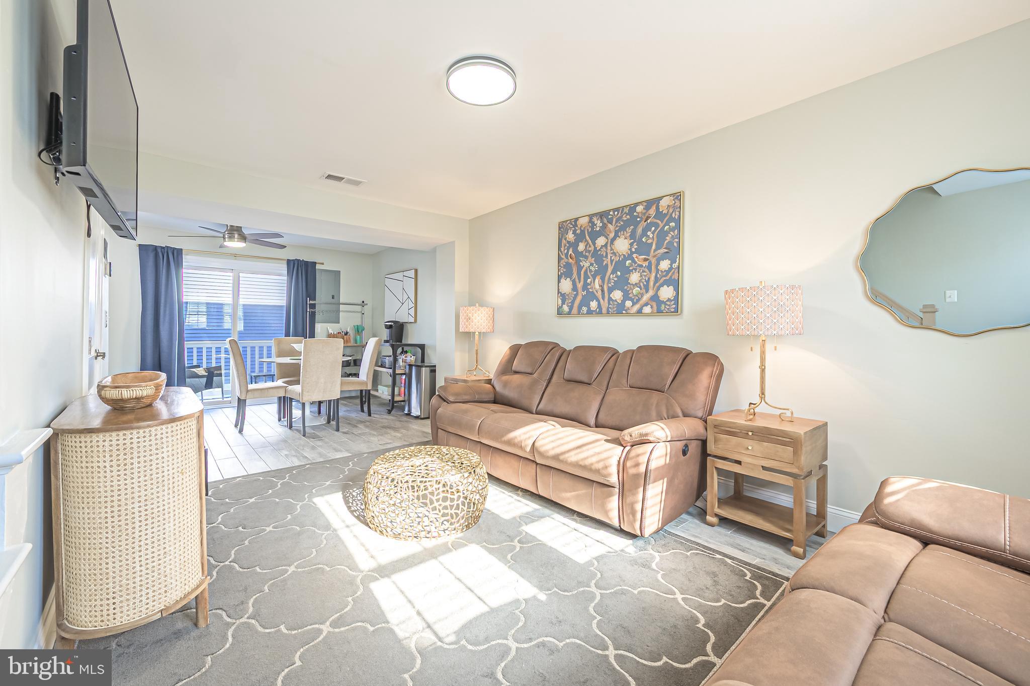 229 10th Street North, Unit 2 Brigantine, NJ 08203 - Photo 2 of 24 a living room with furniture and a flat screen tv
