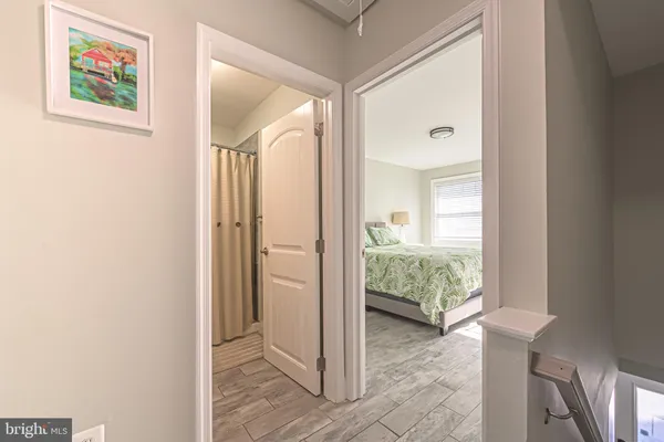 a view of a hallway and a livingroom with furniture
