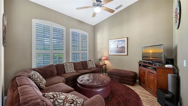 a living room with furniture pool table and a window