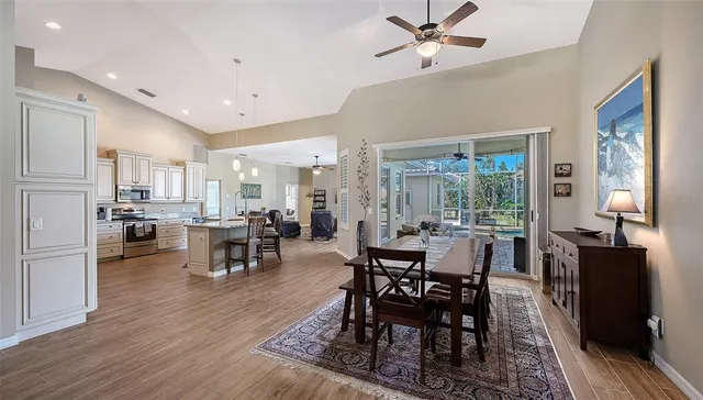 a living room with furniture kitchen view and a window