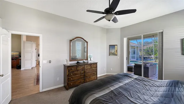an aerial view of a house with outdoor space swimming pool patio and lake view