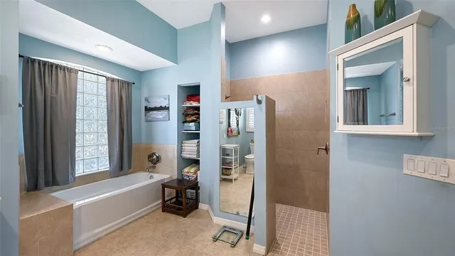 an aerial view of a residential houses with outdoor space and lake view