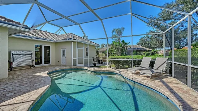 an aerial view of a golf course with a lake view