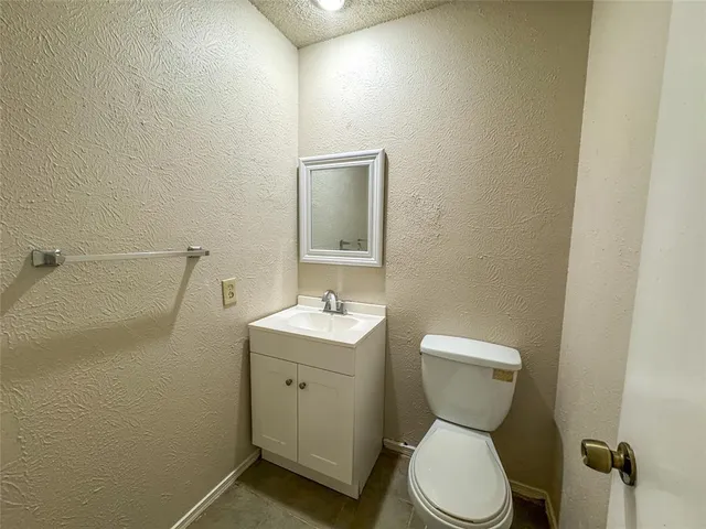 a white toilet sitting next to a bath tub