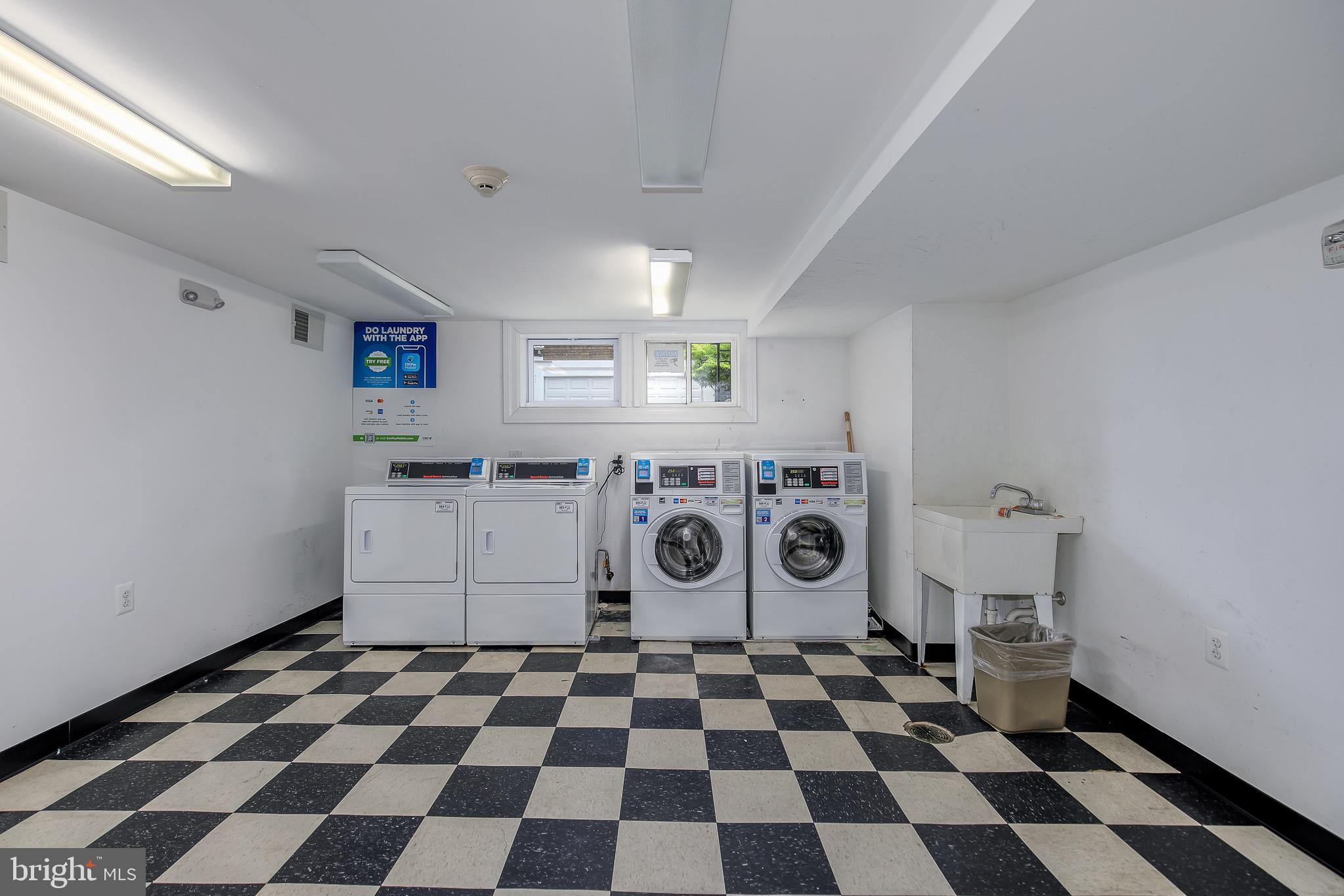 1575 Spring Place Northwest, Unit 23 Washington, DC 20010 - Photo 18 of 23 a kitchen with a checkered floor and white cabinets
