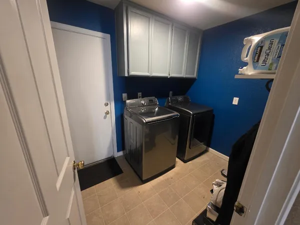 a kitchen with a refrigerator and a stove