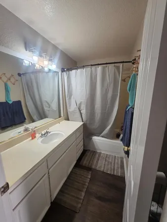 a bathroom with a bathtub a sink and a shower