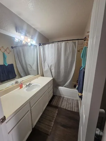 a bathroom with a bathtub a sink and a shower