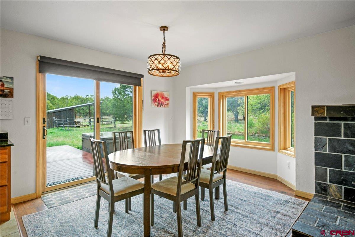 1010 Canyon Drive Ridgway, CO 81432 - Photo 12 of 38 a view of a dining room with furniture wooden floor and chandelier