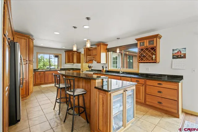 a kitchen that has a table and chairs in it