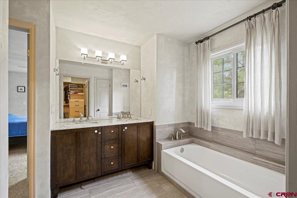 1010 Canyon Drive Ridgway, CO 81432 - Photo 18 of 38 a spacious bathroom with a tub sink and mirror