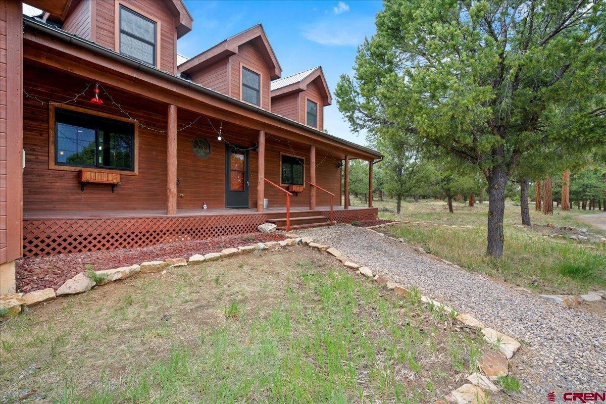 1010 Canyon Drive Ridgway, CO 81432 - Photo 2 of 37 a backyard of a house with barbeque oven table and chairs