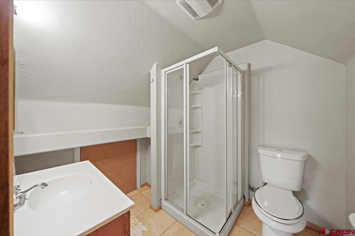 1010 Canyon Drive Ridgway, CO 81432 - Photo 25 of 37 a bathroom with a shower a toilet and a sink