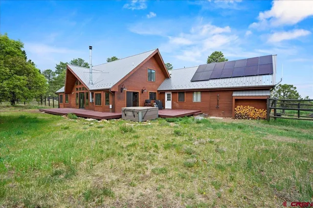 a table and chairs sitting in front of a house