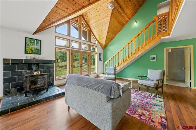 a living room with furniture fireplace and a window