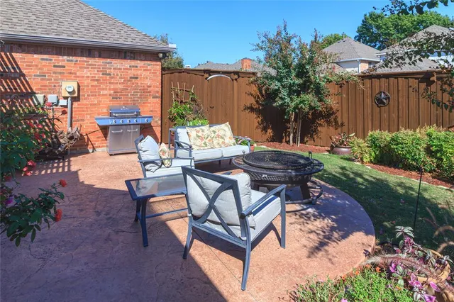 a view of a backyard with sitting area