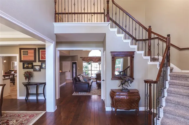 a view of entryway livingroom and hall with wooden floor