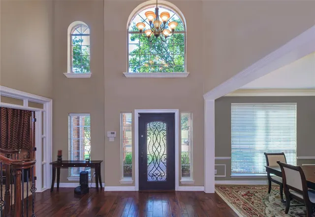 a view of an entryway with wooden floor windows wooden floor and a table