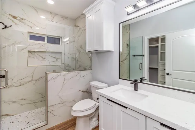 a bathroom with a sink toilet and shower