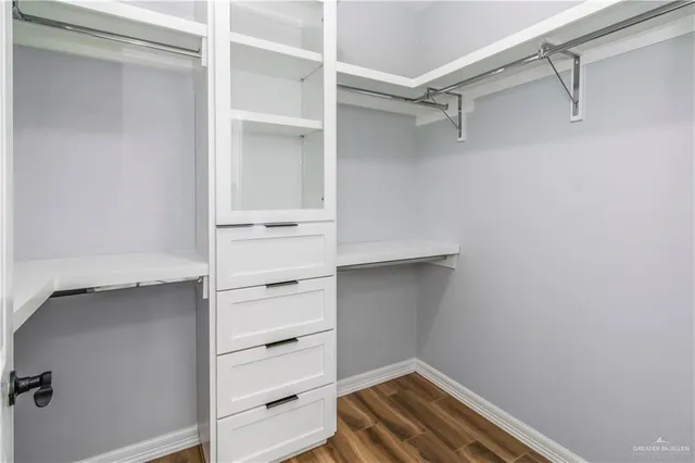a view of walk in closet with empty racks