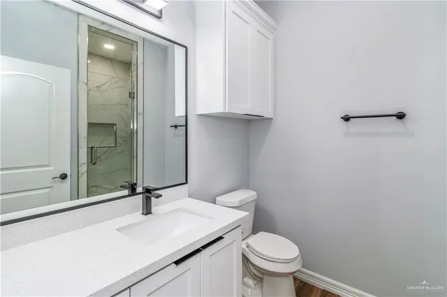 a bathroom with a sink toilet and vanity