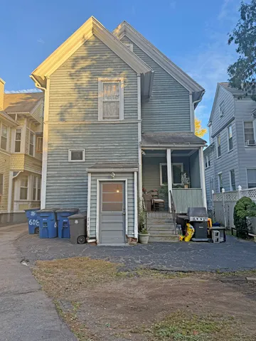 a front view of building with car parked
