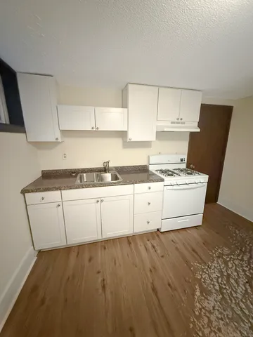 a view of cabinets with wooden floor