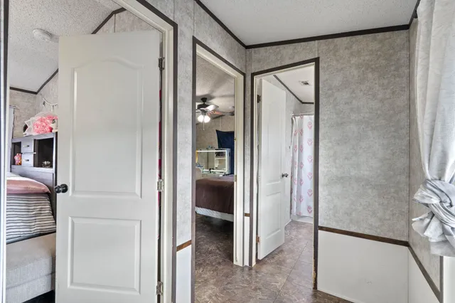 a view of a hallway with wooden shelves
