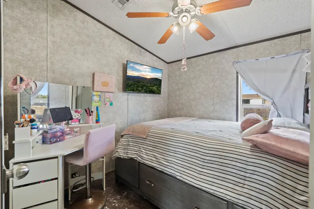 a bedroom that has a bed and a table in it