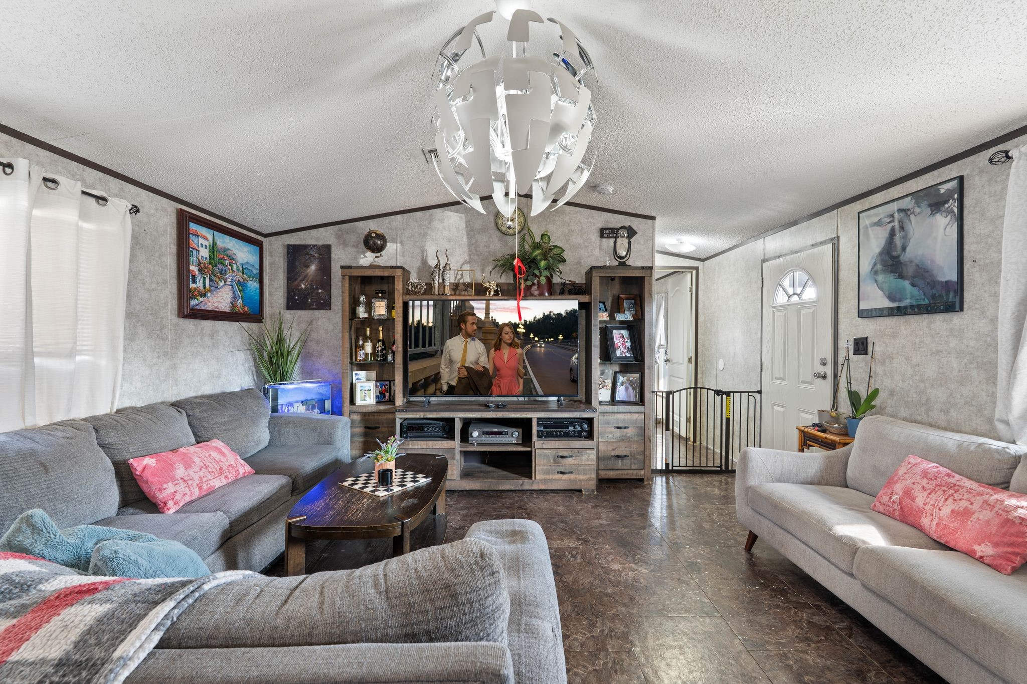 14633 Forest Tower Court Conroe, TX 77306 - Photo 5 of 25 a living room with furniture and a chandelier