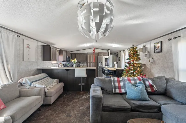 a living room with furniture and a chandelier