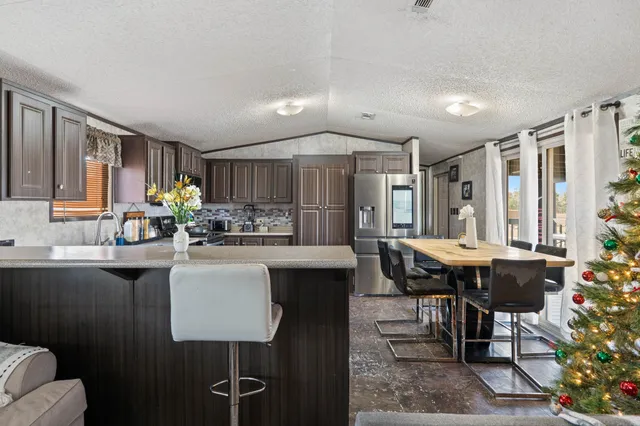 a kitchen with a table chairs stove and cabinets