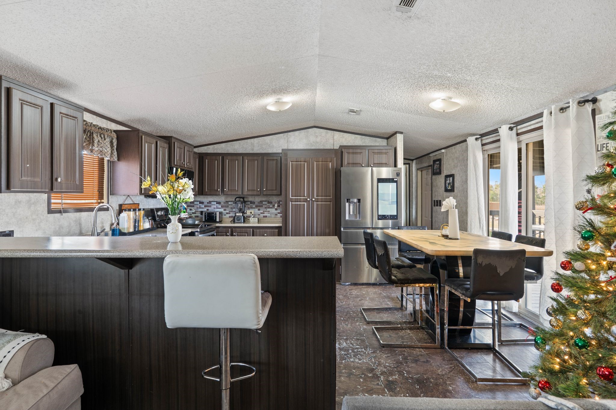 14633 Forest Tower Court Conroe, TX 77306 - Photo 7 of 25 a kitchen with a table chairs stove and cabinets