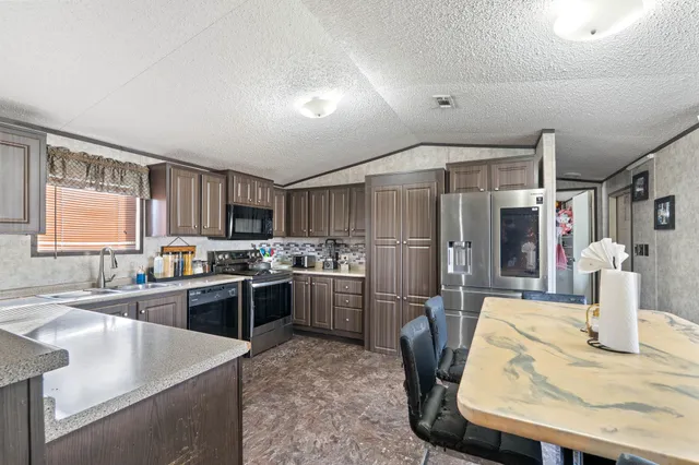 a kitchen with refrigerator and stove