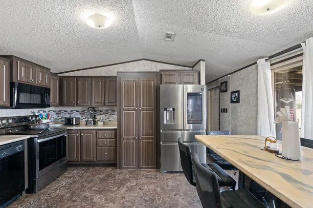 a kitchen with sink cabinets and stainless steel appliances