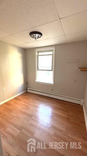 47 Richardson Street New Brunswick, NJ 08901 - Photo 6 of 11 an empty room with wooden floor and windows