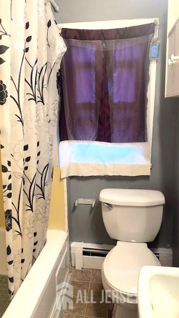 47 Richardson Street New Brunswick, NJ 08901 - Photo 9 of 11 a bathroom with a toilet and a shower curtain