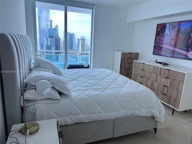 a large white bed in a white room