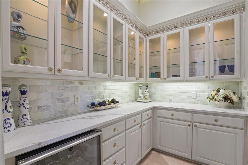 6512 Old Gate Road Plano, TX 75024 - Photo 12 of 40 The dry bar is just across from the wine storage room and offers abundant cabinetry and storage.
