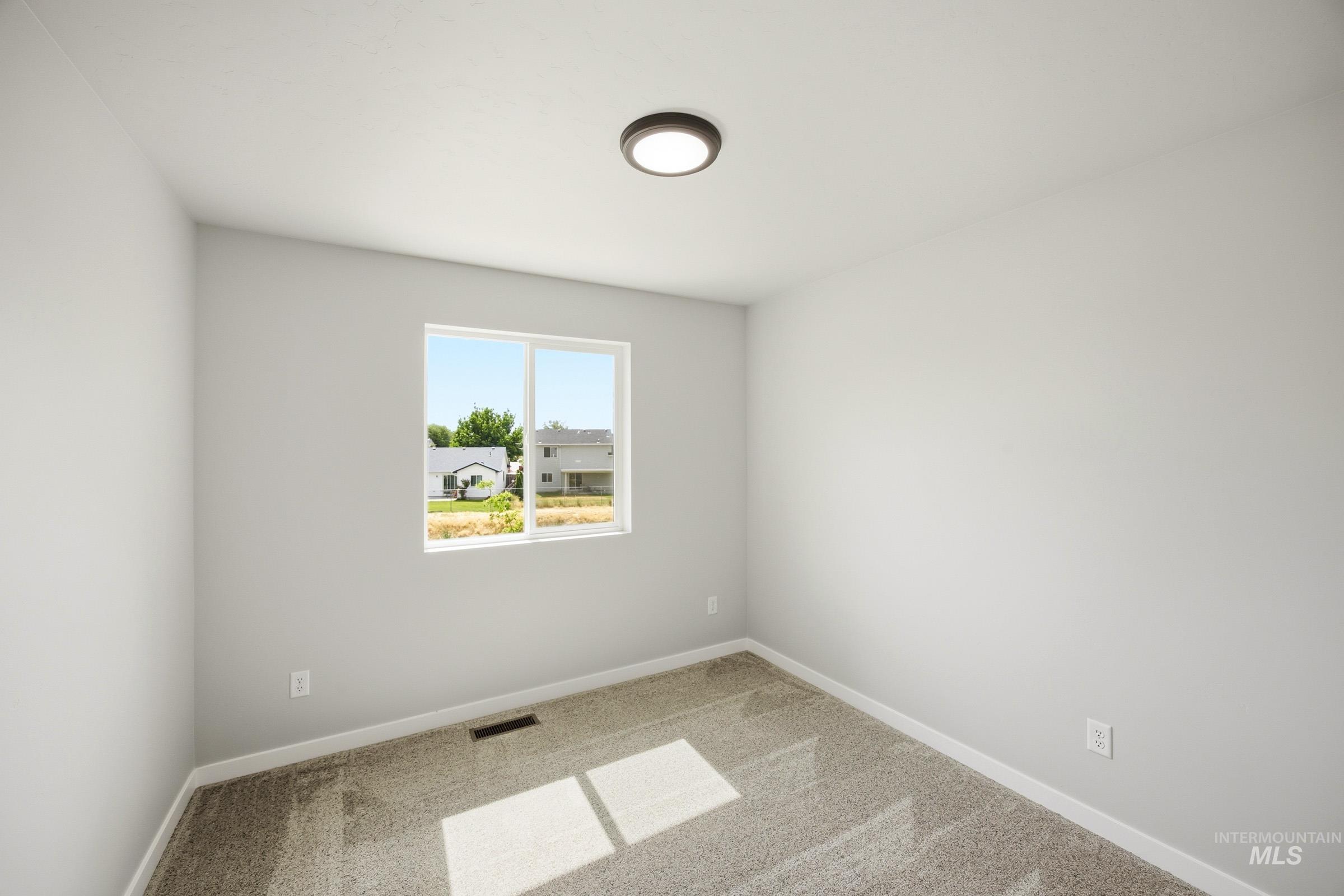 14044 Shiny Spruce Street Caldwell, ID 83607 - Photo 23 of 24 Neutral interior room featuring a double-pane window, flush-mount ceiling light, light gray walls, and carpet flooring