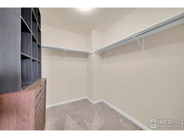 a bedroom with a bed and a wall painting