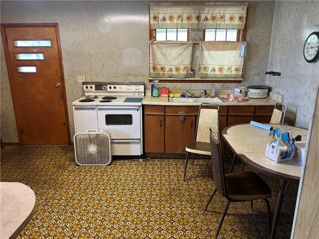 a kitchen with a sink stove and cabinets
