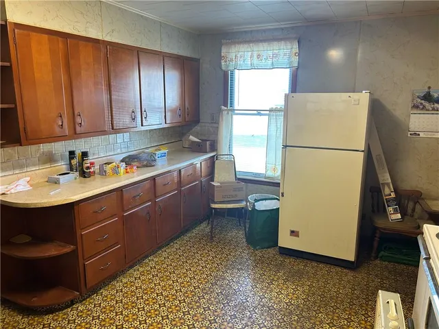 a room with a chair and appliances