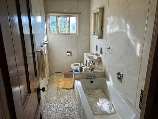 a bathroom with a tub and shower