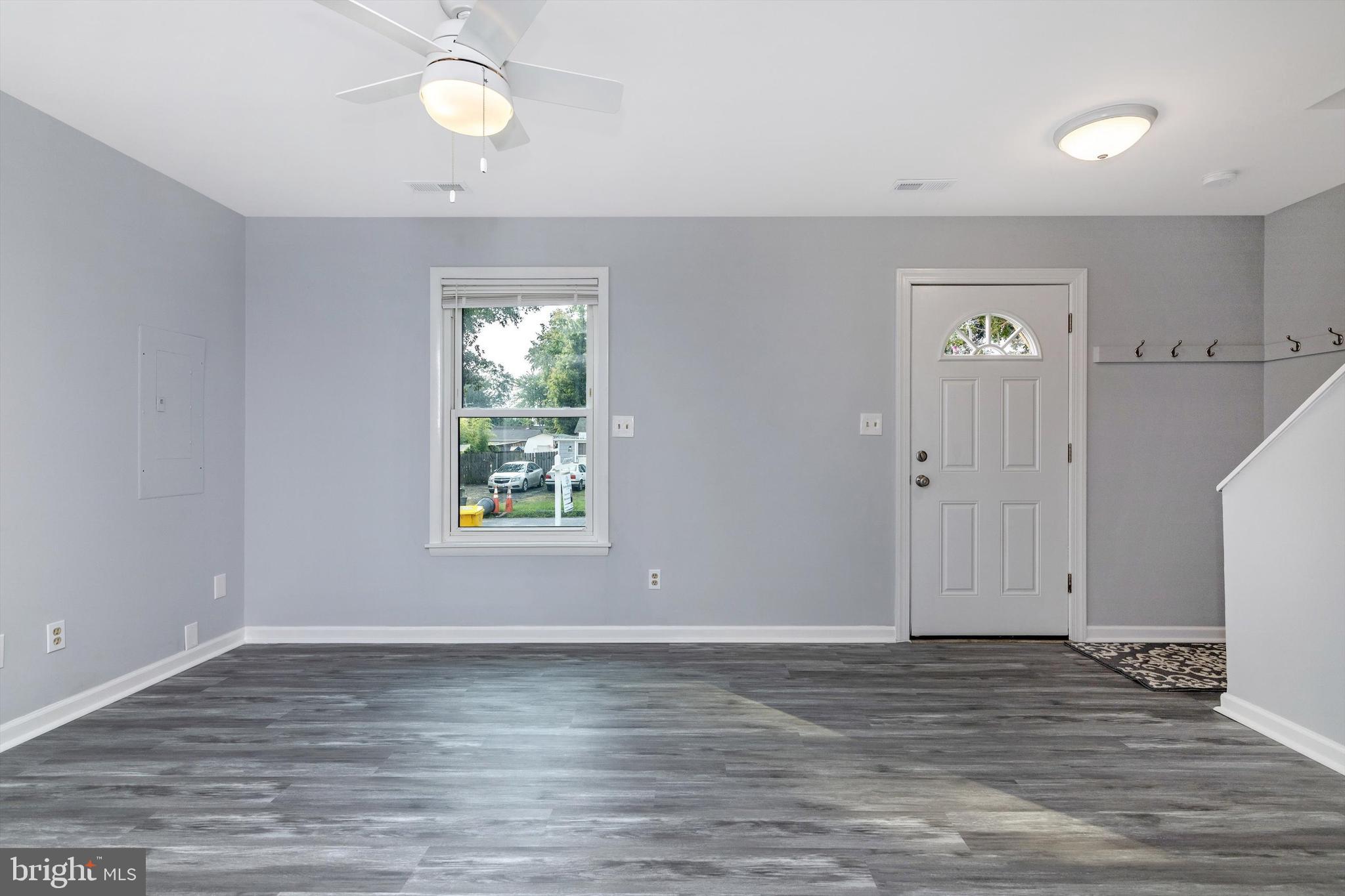 1702 Potomac Road Edgewater, MD 21037 - Photo 26 of 41 a view of an empty room with window and hardwood floor