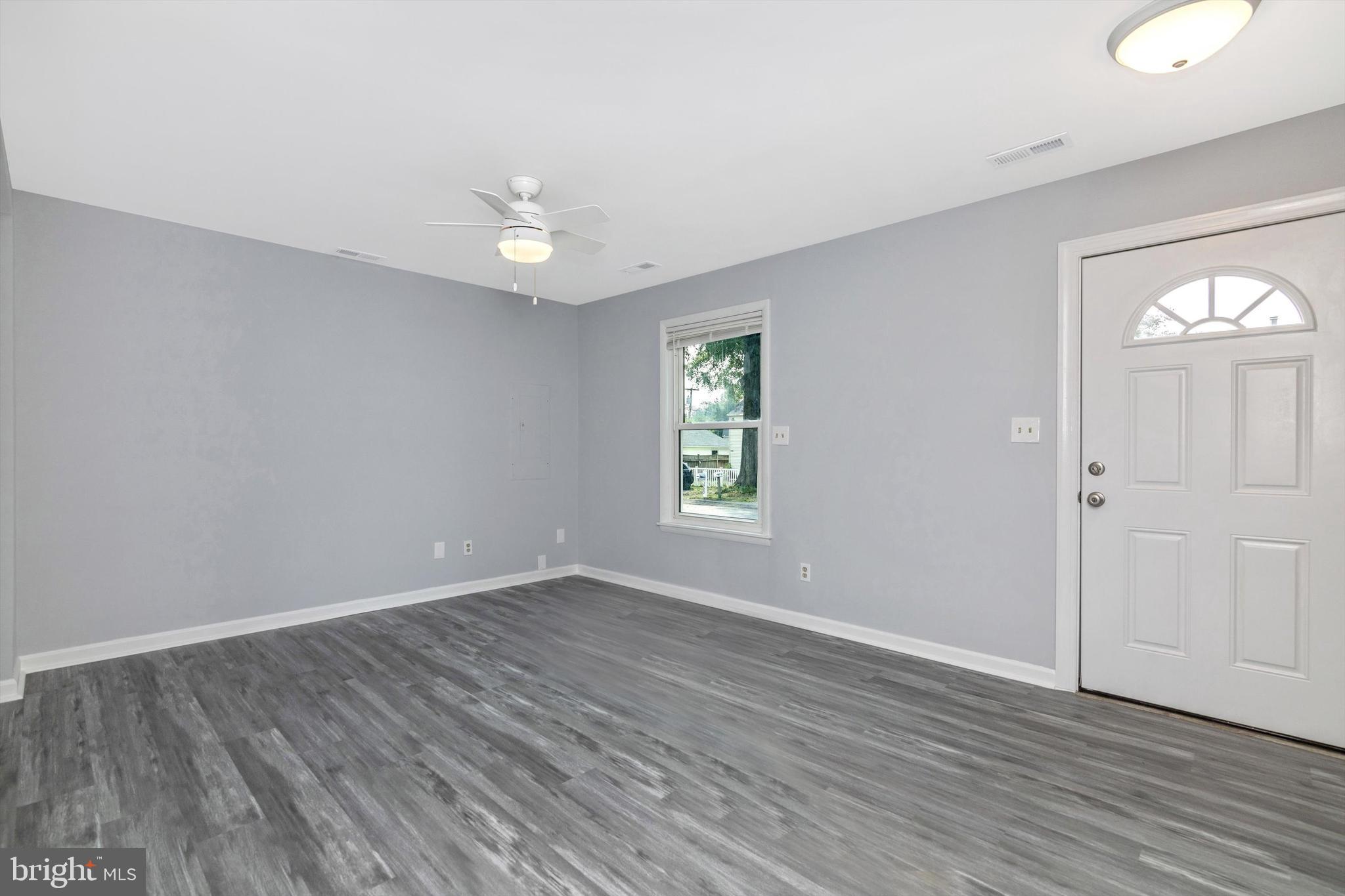 1702 Potomac Road Edgewater, MD 21037 - Photo 27 of 41 an empty room with wooden floor and windows
