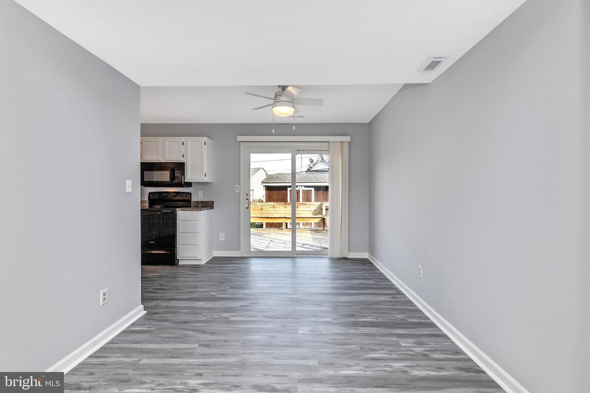 1702 Potomac Road Edgewater, MD 21037 - Photo 29 of 41 a view of an empty room with window and wooden floor