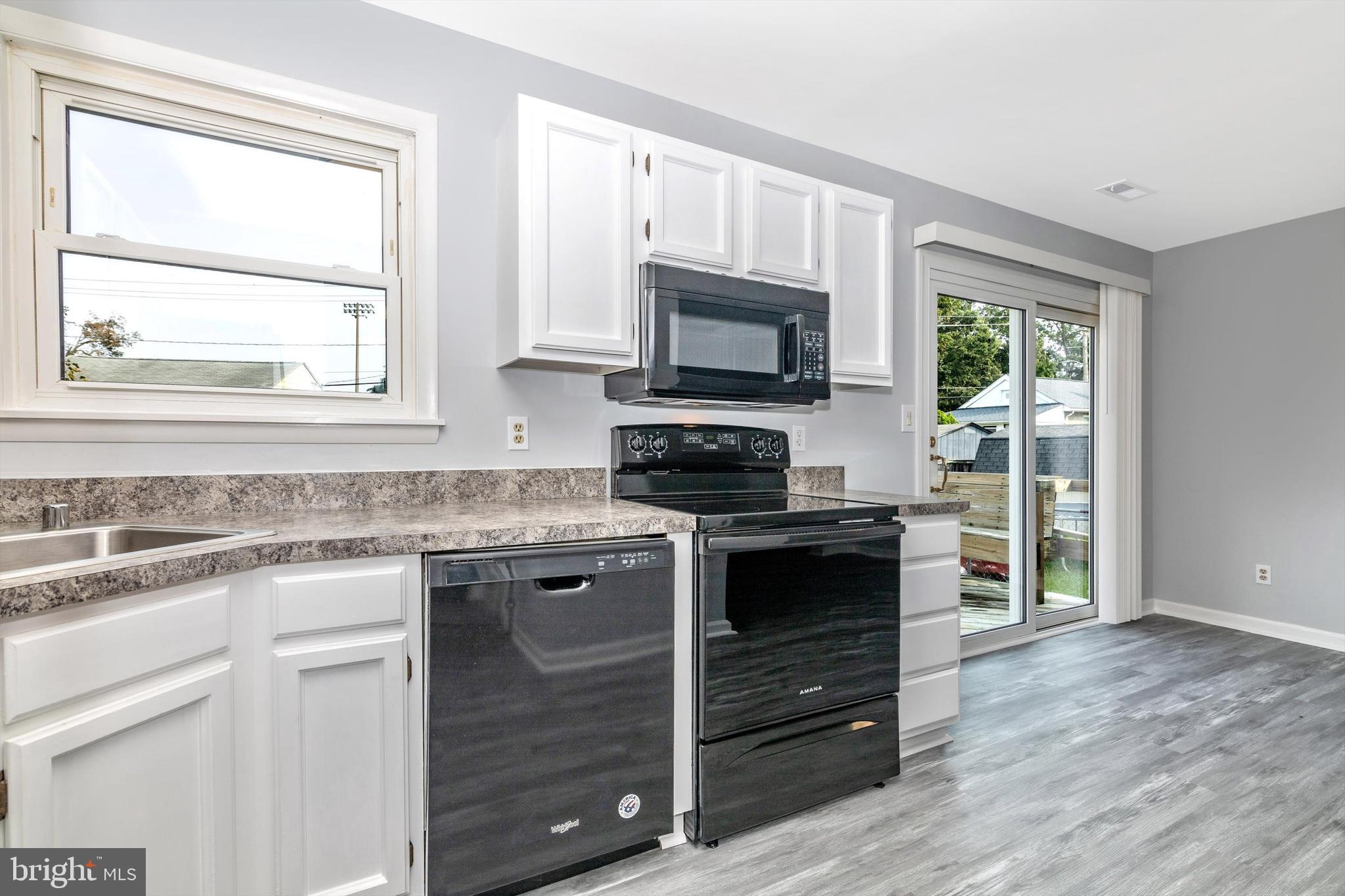 1702 Potomac Road Edgewater, MD 21037 - Photo 4 of 41 a kitchen with a stove a sink and a window