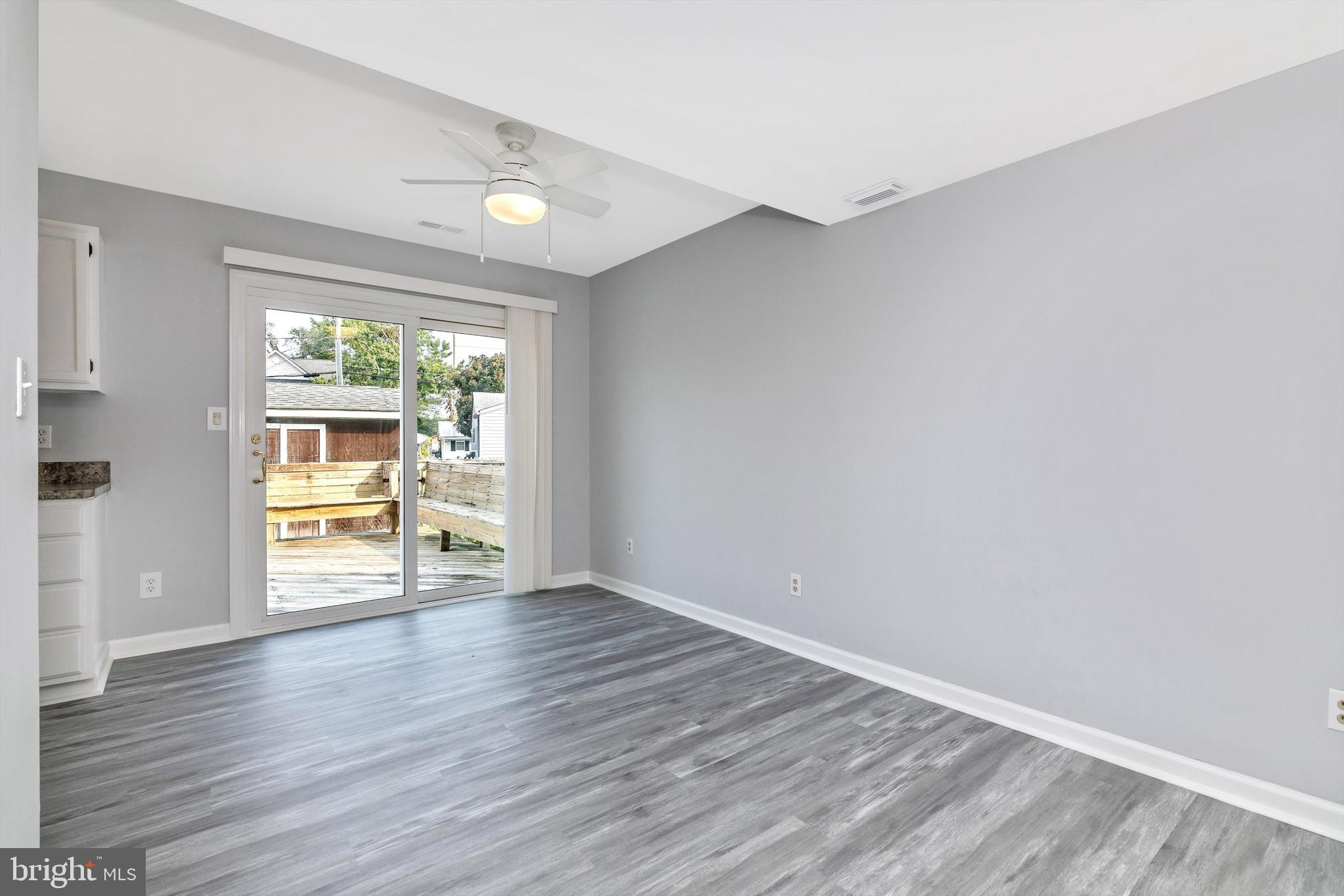 1702 Potomac Road Edgewater, MD 21037 - Photo 30 of 41 a view of an empty room with wooden floor and a window